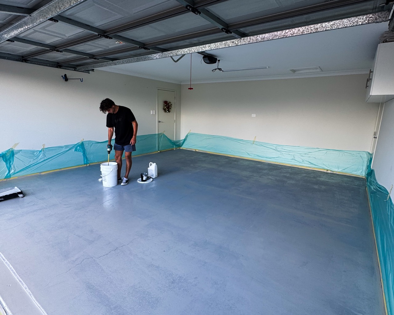 Epoxy base coat being applied to a residential garage floor